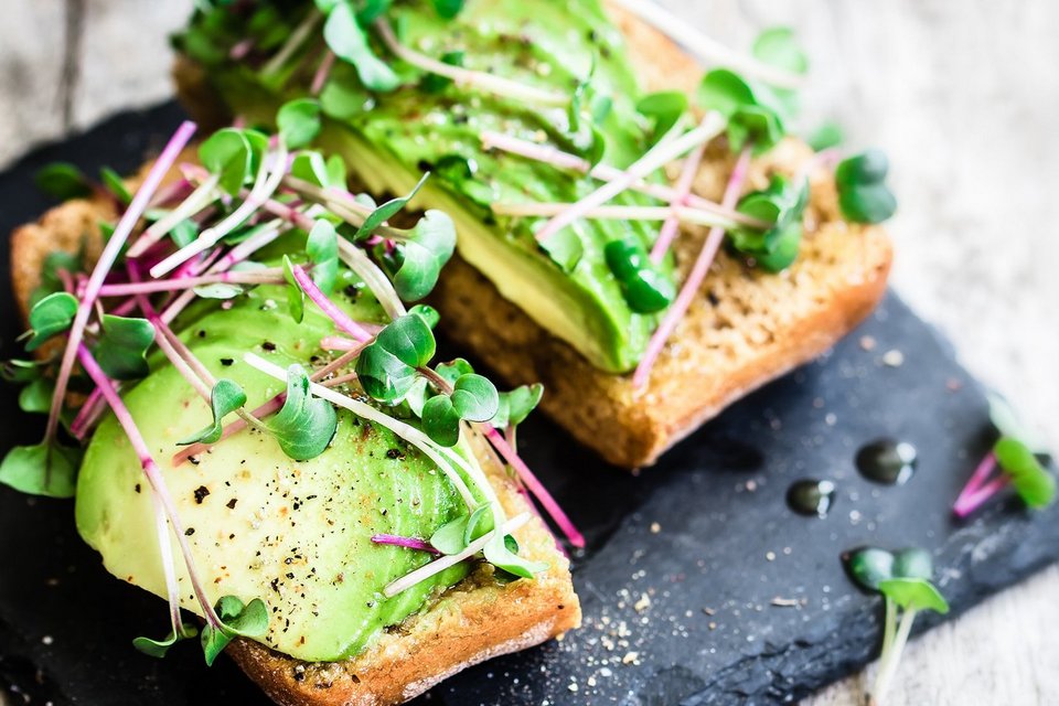 Avocado auf frischem Brot mit Kräutern und gewürzt 